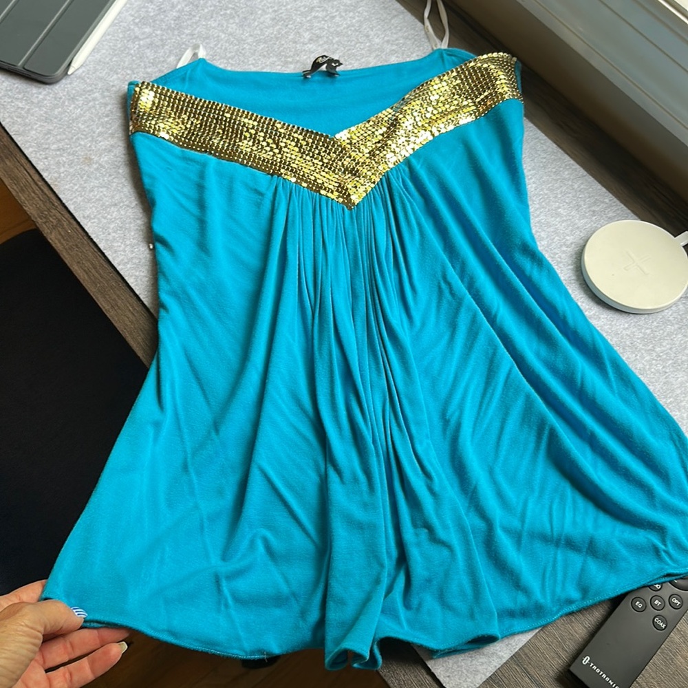Beautiful turquoise sky top. Strapless with chainmail detailing